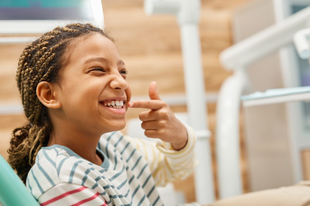 Girl Pointing at Teeth